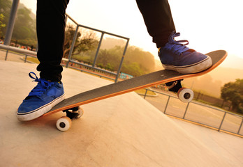 Fototapeta na wymiar sunrise skateboarding woman legs