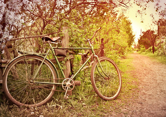 Fototapeta na wymiar Old bike at the fence. village Street