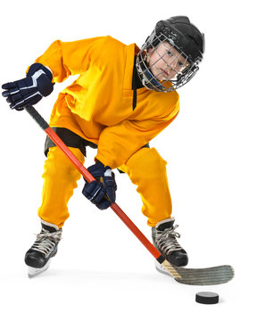 Young hockey player with stick and puck