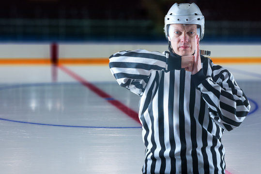 Hockey Referee Demonstrate A Penalty