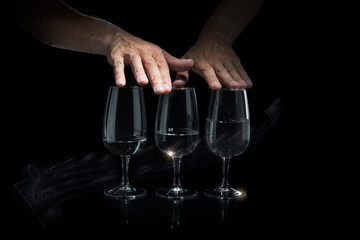 Man hands playing music on glass cups