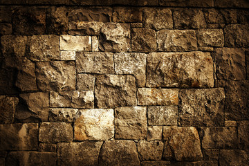 Rough brown rock block wall background