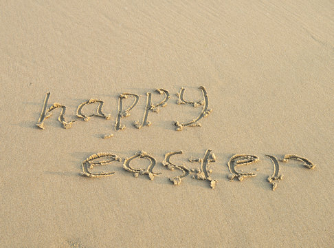 Happy easter written on a sand