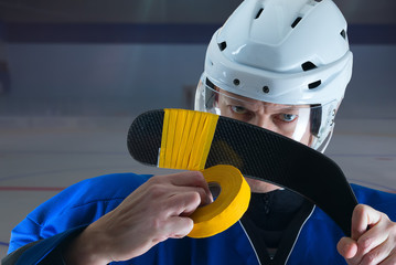 Portrait of Hockey player taping his stick