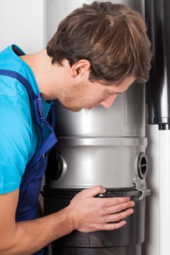 Man Opening Central Vacuum Cleaner