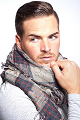 Portrait of a beautiful young man with scarf