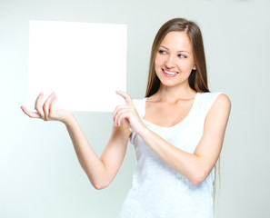 young smiling woman holding blank card