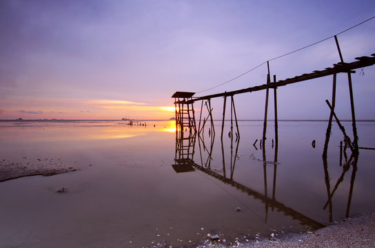 old bridge at jeram beach during sunset