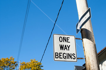 One way begins street sign