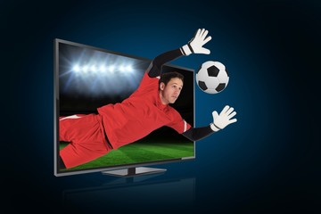 Fit goal keeper saving goal through tv