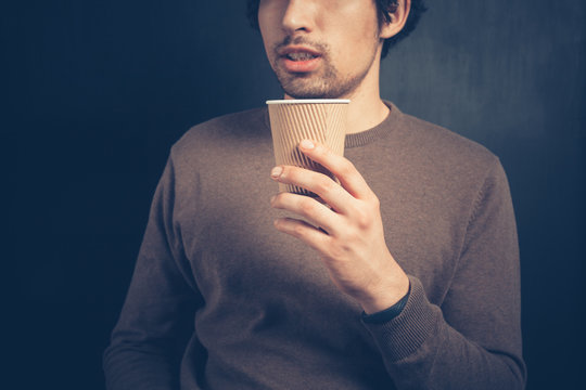 Young man with a paper cup