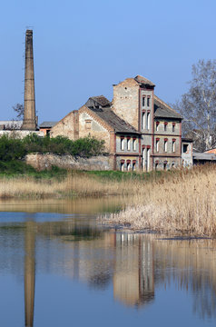 old ruined factory on lake