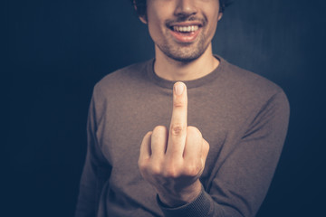Young man displaying obscene gesture