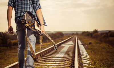 guitarist on a road to horizon