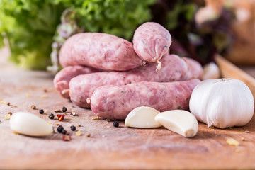 Raw sausages with garlic, spices and lettuce