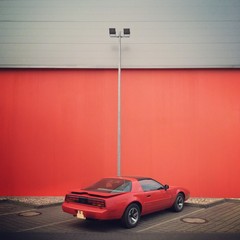 red car in front of red wall in Berlin