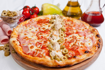 Pizza with green olives and ham
