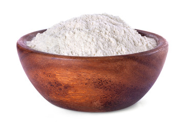 flour in a wooden bowl on a white background