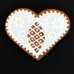 heart shaped gingerbread cookie isolated on black