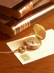 pocket watch and books