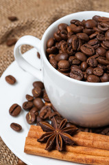 Coffee beans and coffee cup close-up vertical