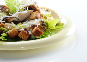 Caesar chicken salad on white background