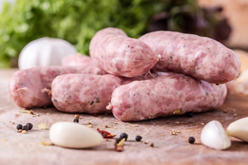 Raw sausages with garlic, spices and lettuce