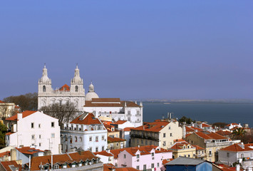 Obraz premium View on the old roofs and basilica in the center of Lisbon