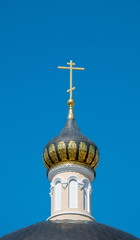 dome decorated with gold leaf and a cross