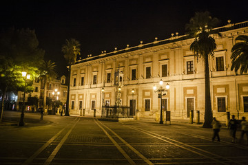 Fototapeta na wymiar Narrow street in Seville at night, Spain