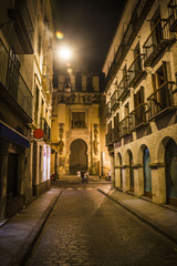 Fototapeta na wymiar Narrow street in Seville at night, Spain