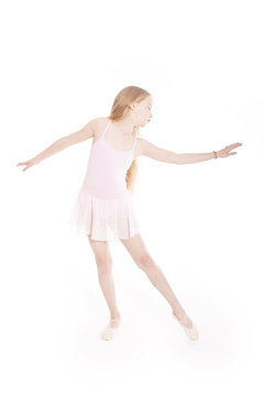 girl dancing in pink ballet suit in studio