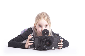 young girl with large old fashioned camera in studio