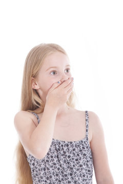 young blond girl with hand on mouth in studio