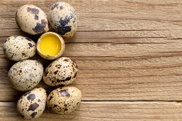 Quail eggs on wooden background