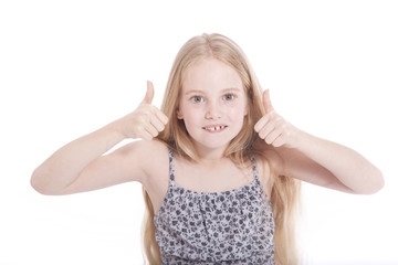 young girl in studio with both thumbs up