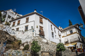 Fototapeta na wymiar The narrow street with old houses, Granada, Spain.
