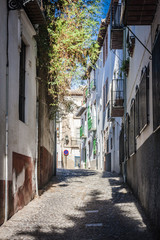 The narrow street with old houses, Granada, Spain.
