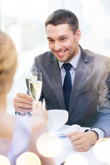 couple with glasses of champagne at restaurant