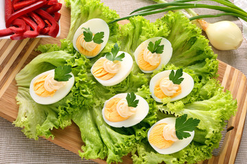 Eggs with mayonnaise on wood background