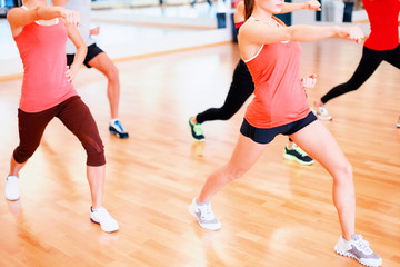 Fototapeta premium group of smiling people exercising in the gym