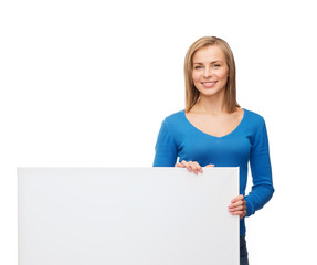smiling woman in sweater with blank white board
