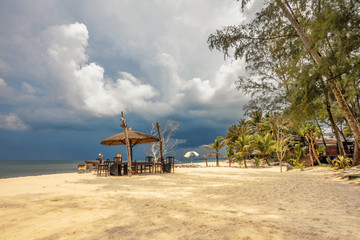 Wooden umbrella on white sand beach