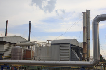 Industrial zone, Steel pipelines and valves against blue sky