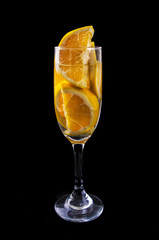 orange slices on a glass on wine with dark background