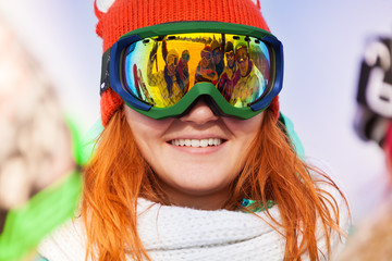 Happy young woman in ski mask with reflection