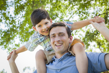 Father and Son Playing Piggyback in the Park