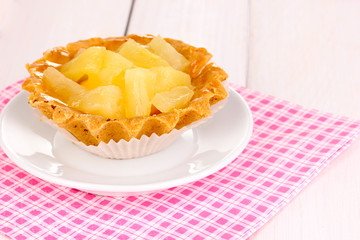 sweet cake with fruits on wooden background