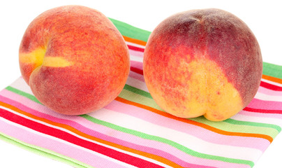 ripe peaches on napkin isolated on white.