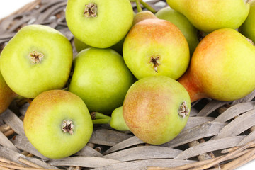 ripe pears on wicker mat close-up